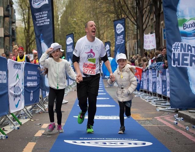 Jamie Cotsen at the marathon finish line with his two children 