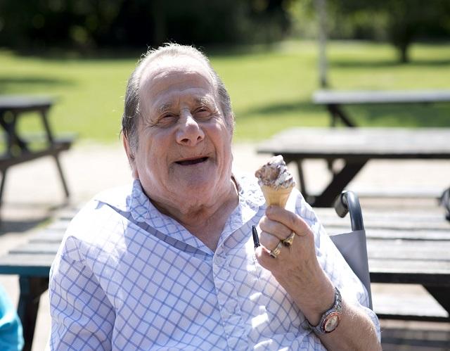 Man in wheelchair holding an ice cream 
